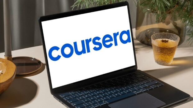 A laptop shows the Coursera logo on the screen, highlighting online learning options for students
