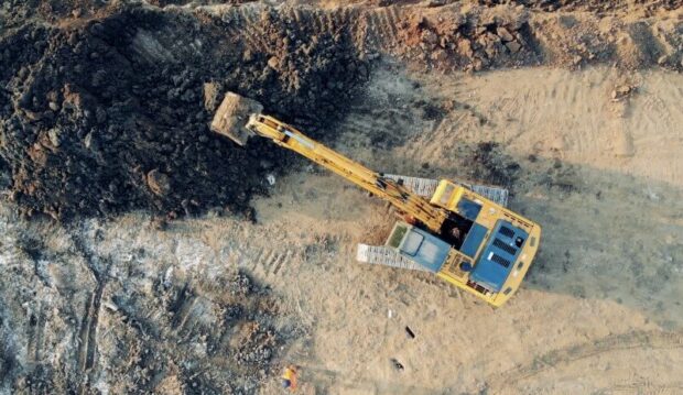 Excavator working on a construction site, moving earth