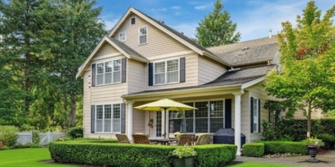 A charming home surrounded by a lush lawn and several trees