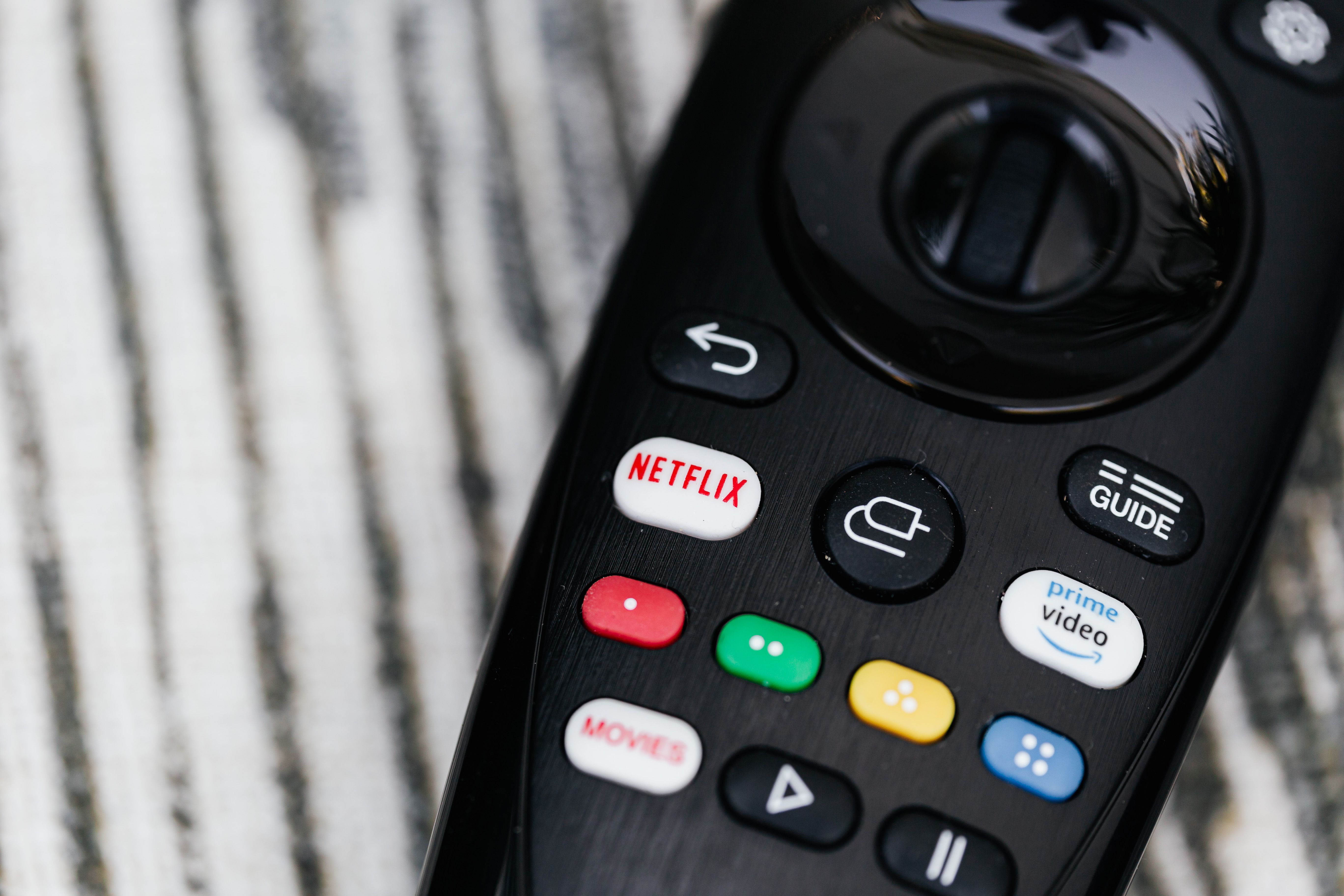 Close-up of a remote control with streaming service buttons for online entertainment